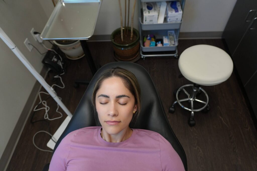 Patient resting comfortably in a chair at NuVida Medical and Aesthetics