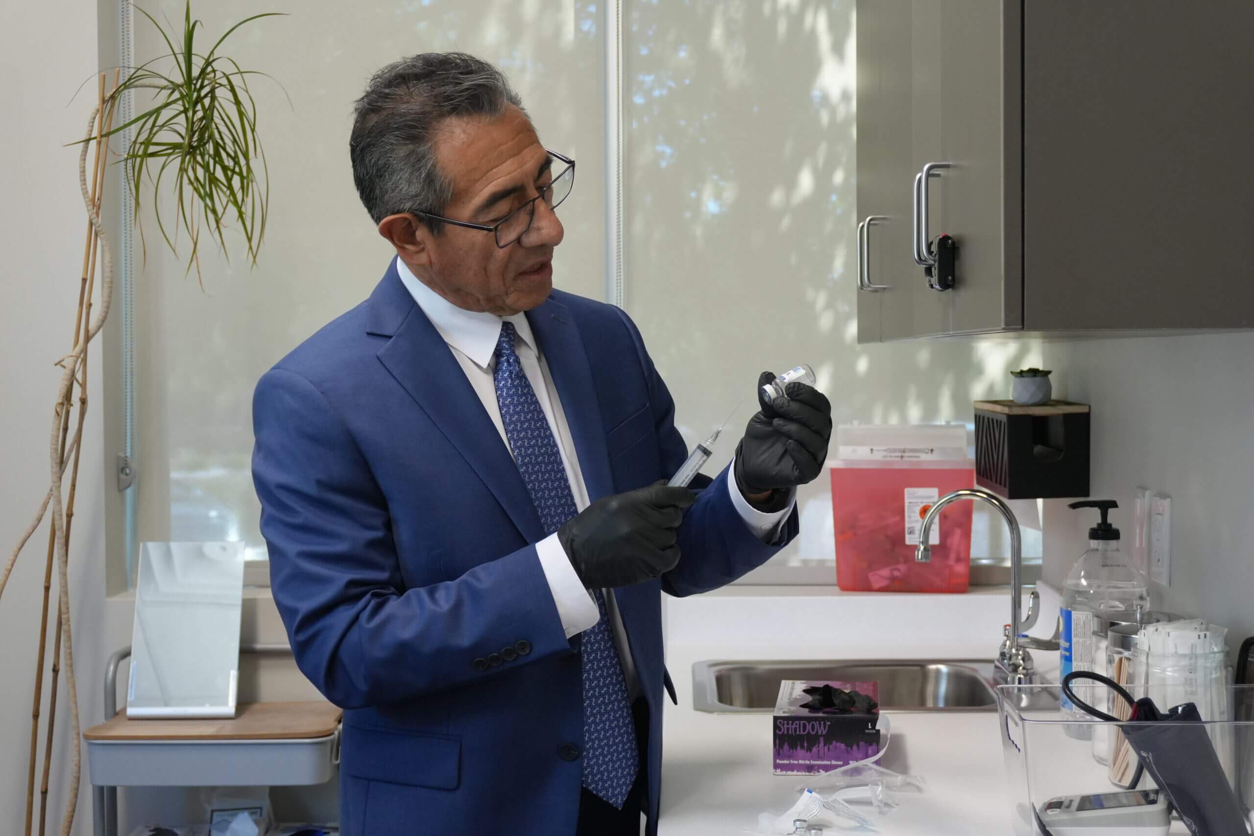 Dr. Mark Paz preparing a therapy at NuVida Medical and Aesthetics